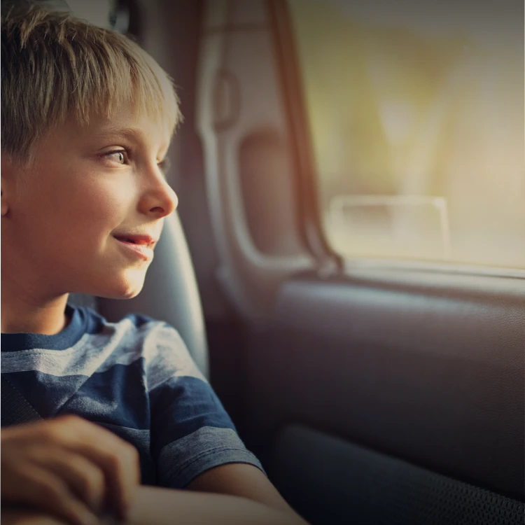 A boy looking out of a car window