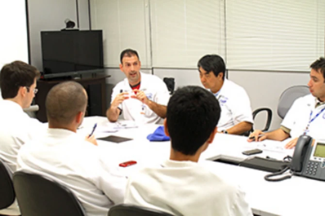 Six employees discussing in a conference room