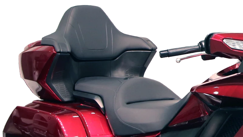 A photo of a large seat with the back of a Honda Goldwing motorcycle.